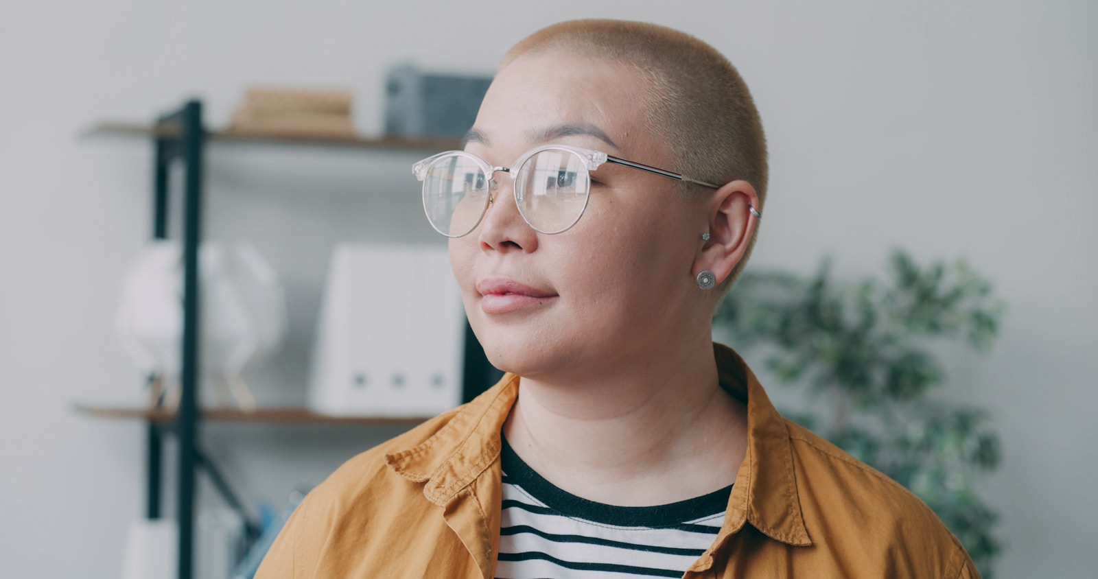 A man with a bald head wearing glasses